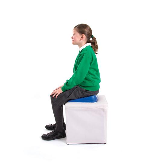 Child sitting on wedge cushion